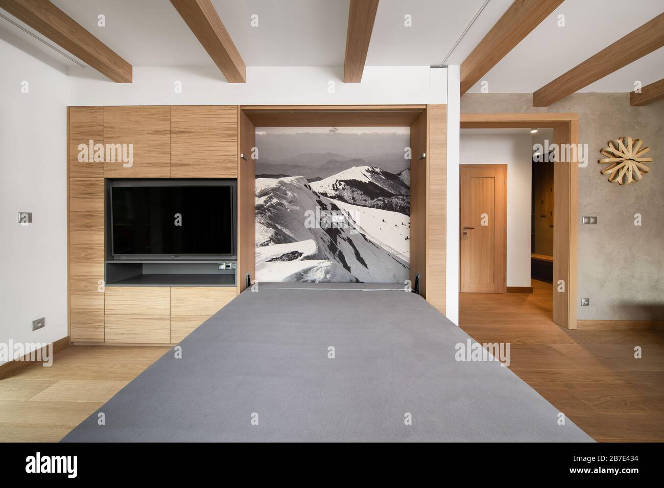 sofa bed built in the wooden wall of the mountain apartment Stock Photo