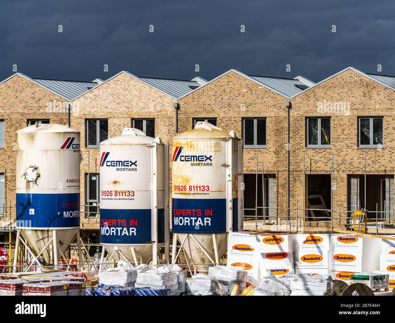 British House Building Site. Cemex Dry Mortar Silos at a building site for new houses in Cambridge. Stock Photo