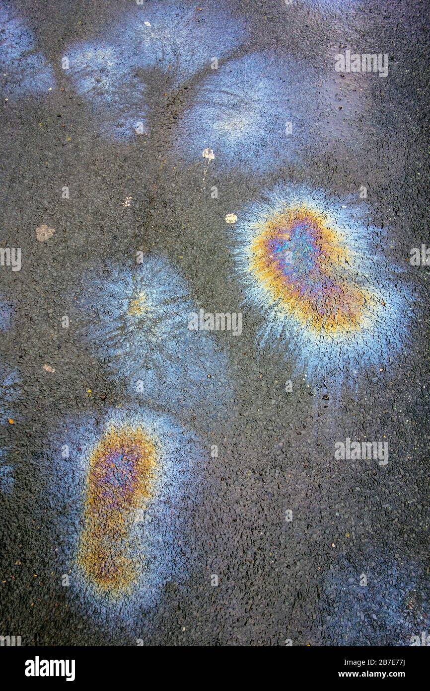 Petrol Gasoline Oil Spill on The Road Tarmac Rainbow Colour Pollution