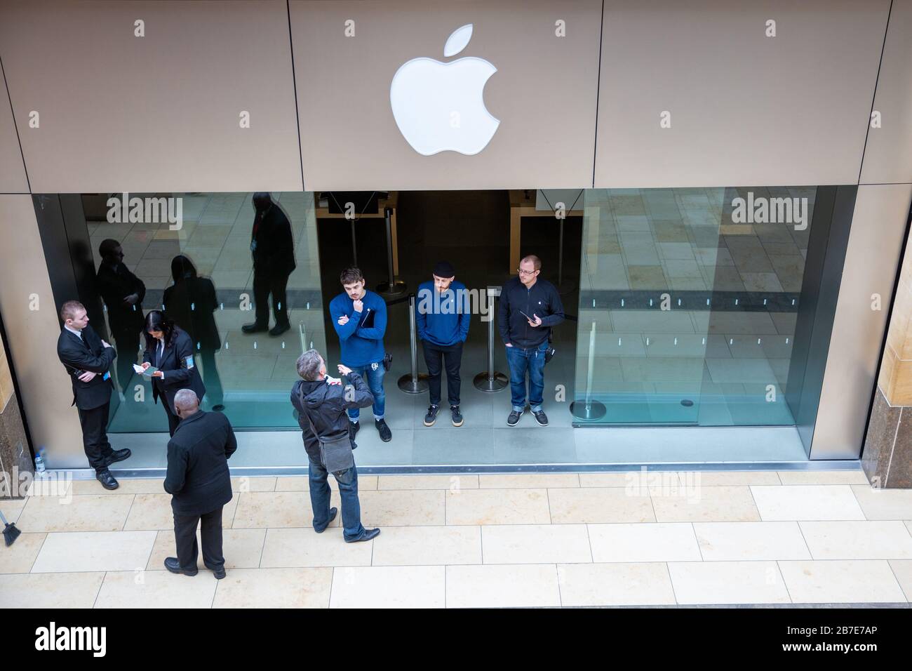 Picture dated March 14th shows staff turning away customers at the Apple store in Cambridge on Saturday morning after all stores were closed due to the Coronavirus outbreak.  Staff and security were seen outside the Apple store in CambridgeÕs Lion Yard today (Sat) after the company closed all its stores across the world for two weeks to help prevent the spread of coronavirus.   The only exception is in China where it has just reopened.   Tim Cook, Apple's CEO, made the announcement on Twitter early this morning (Sat). Stock Photo