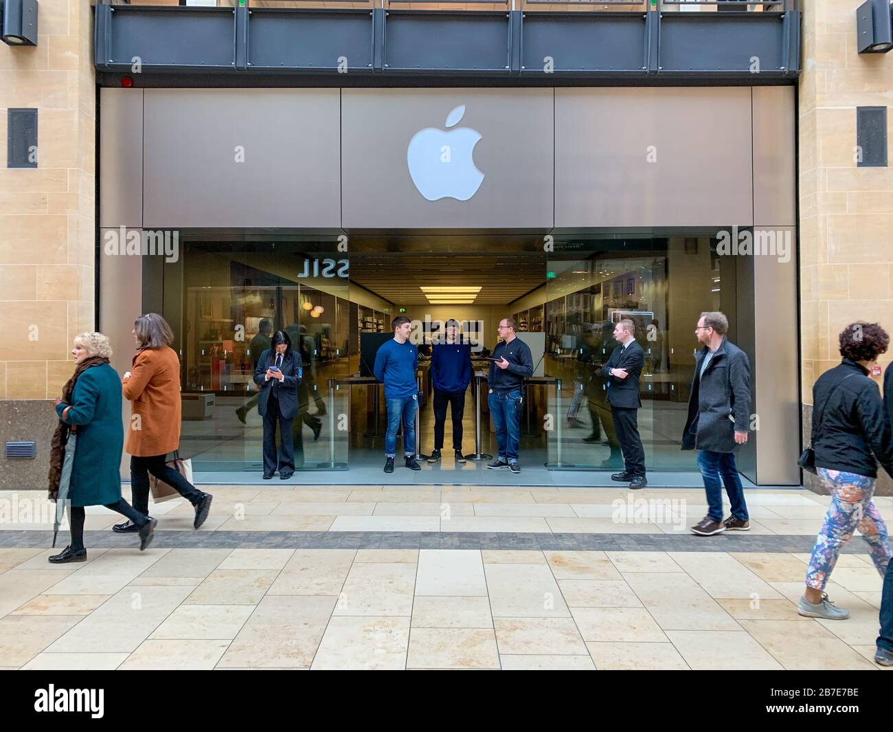 Picture dated March 14th shows staff turning away customers at the Apple store in Cambridge on Saturday morning after all stores were closed due to the Coronavirus outbreak.  Staff and security were seen outside the Apple store in CambridgeÕs Lion Yard today (Sat) after the company closed all its stores across the world for two weeks to help prevent the spread of coronavirus.   The only exception is in China where it has just reopened.   Tim Cook, Apple's CEO, made the announcement on Twitter early this morning (Sat). Stock Photo