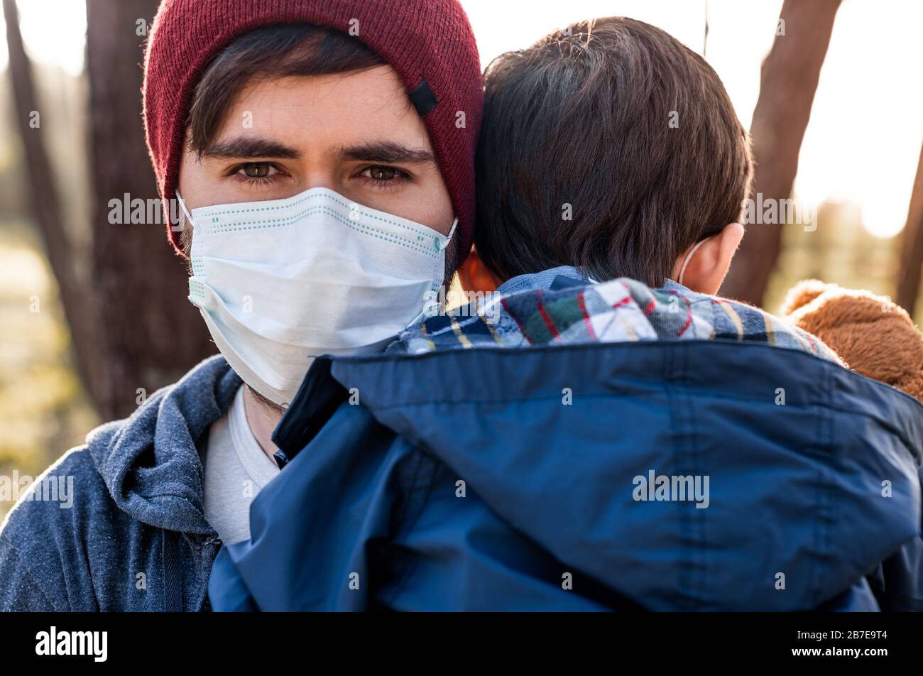 Concerned father and son using air protection masks Stock Photo