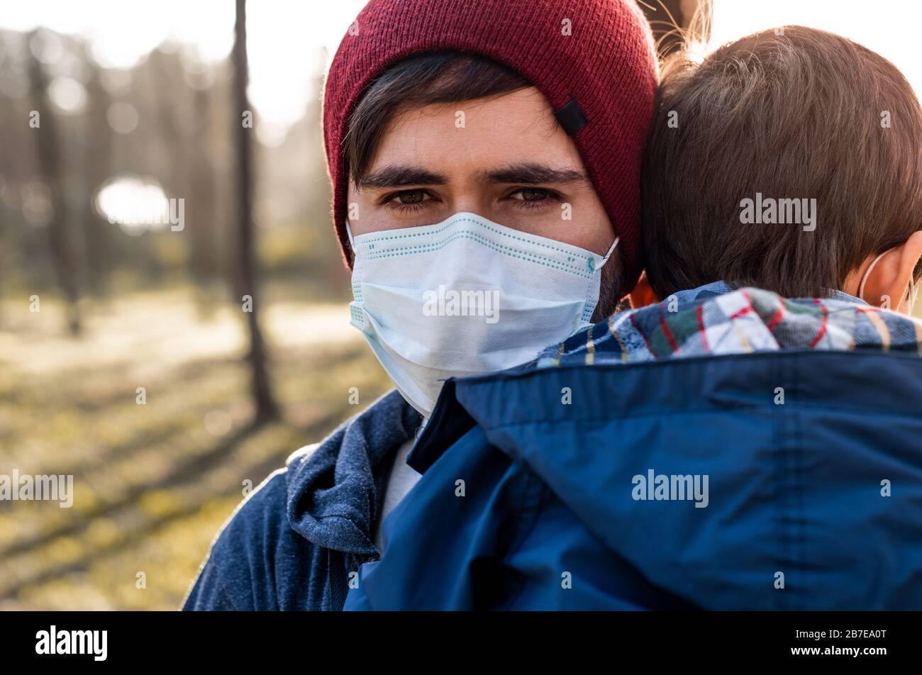 Concerned father and son using air protection masks Stock Photo