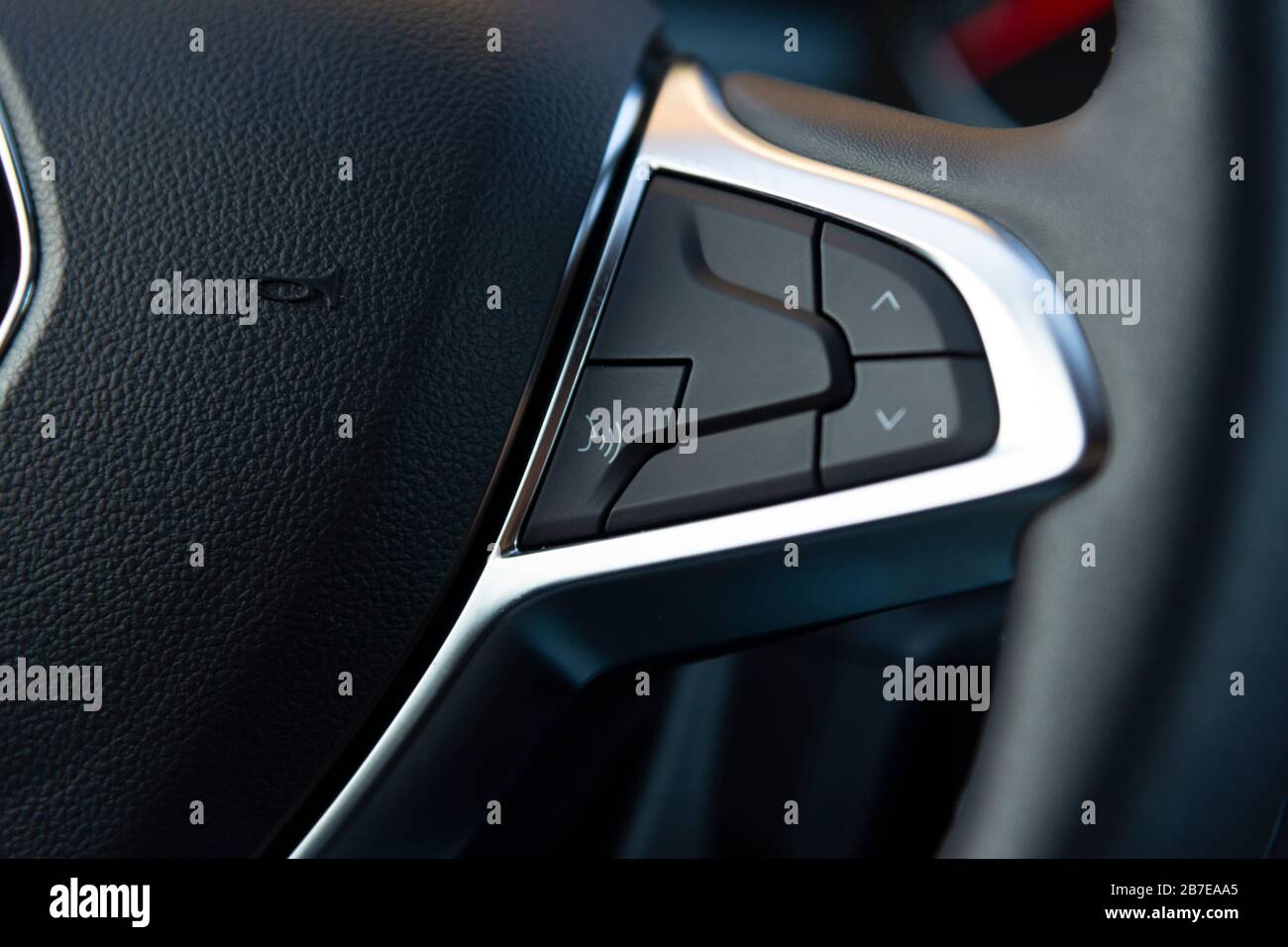 Voice control button on the steering wheel of a modern car Stock Photo