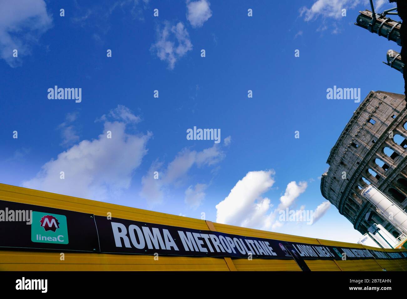 Construction site for the new C metro line, subway, underground. Signage in the foreground, Colosseum on the background. Rome historic centre. Italy. Stock Photo