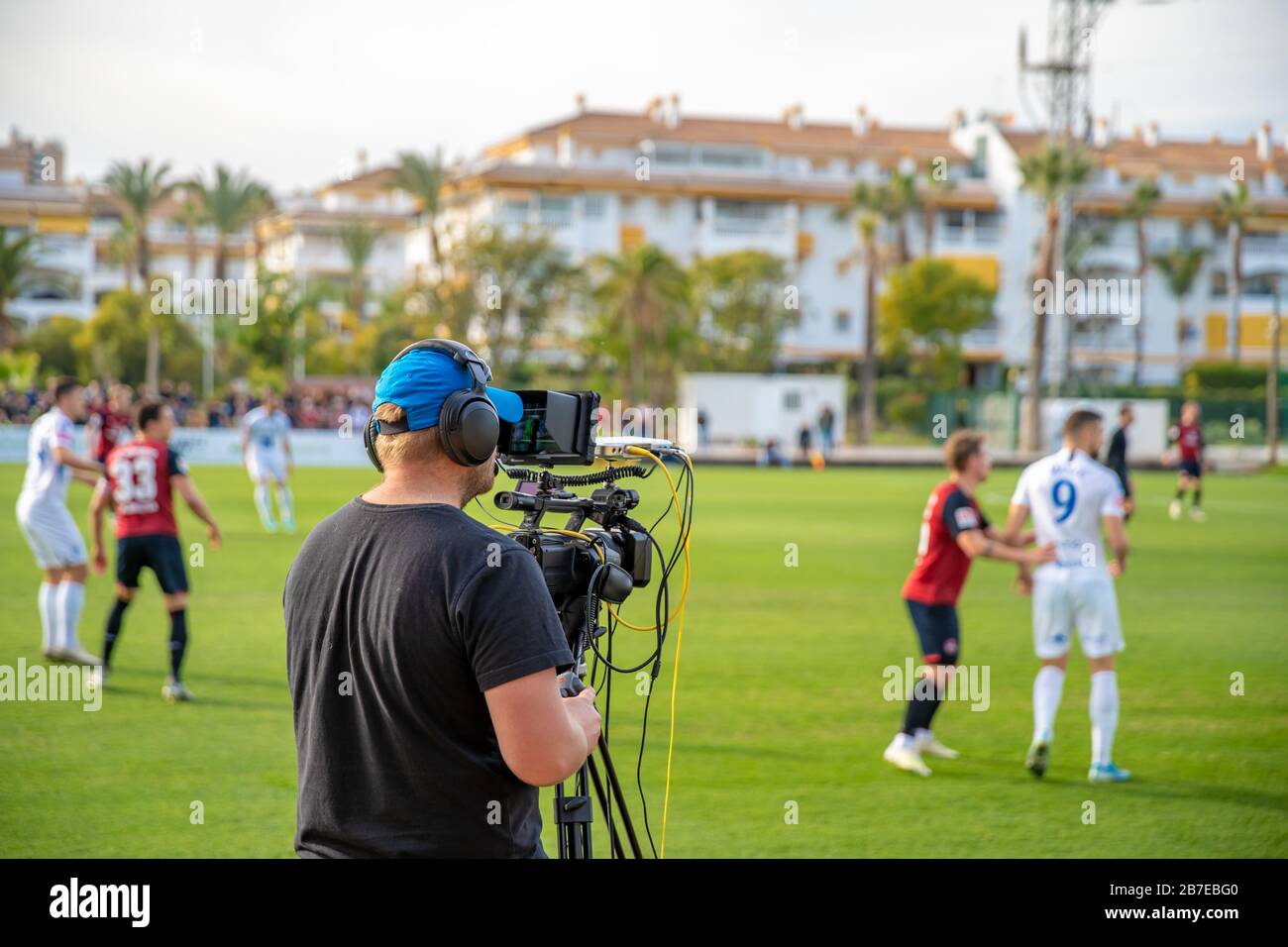 cameraman with camera shooting video on football game Stock Photo Alamy