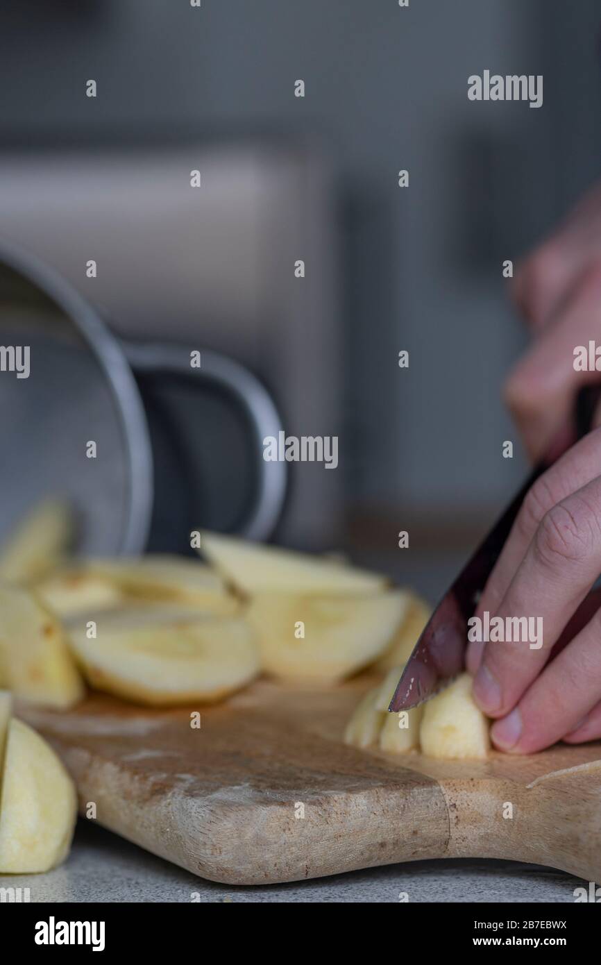 Peeling apples for apple pie hand visible. Stock Photo