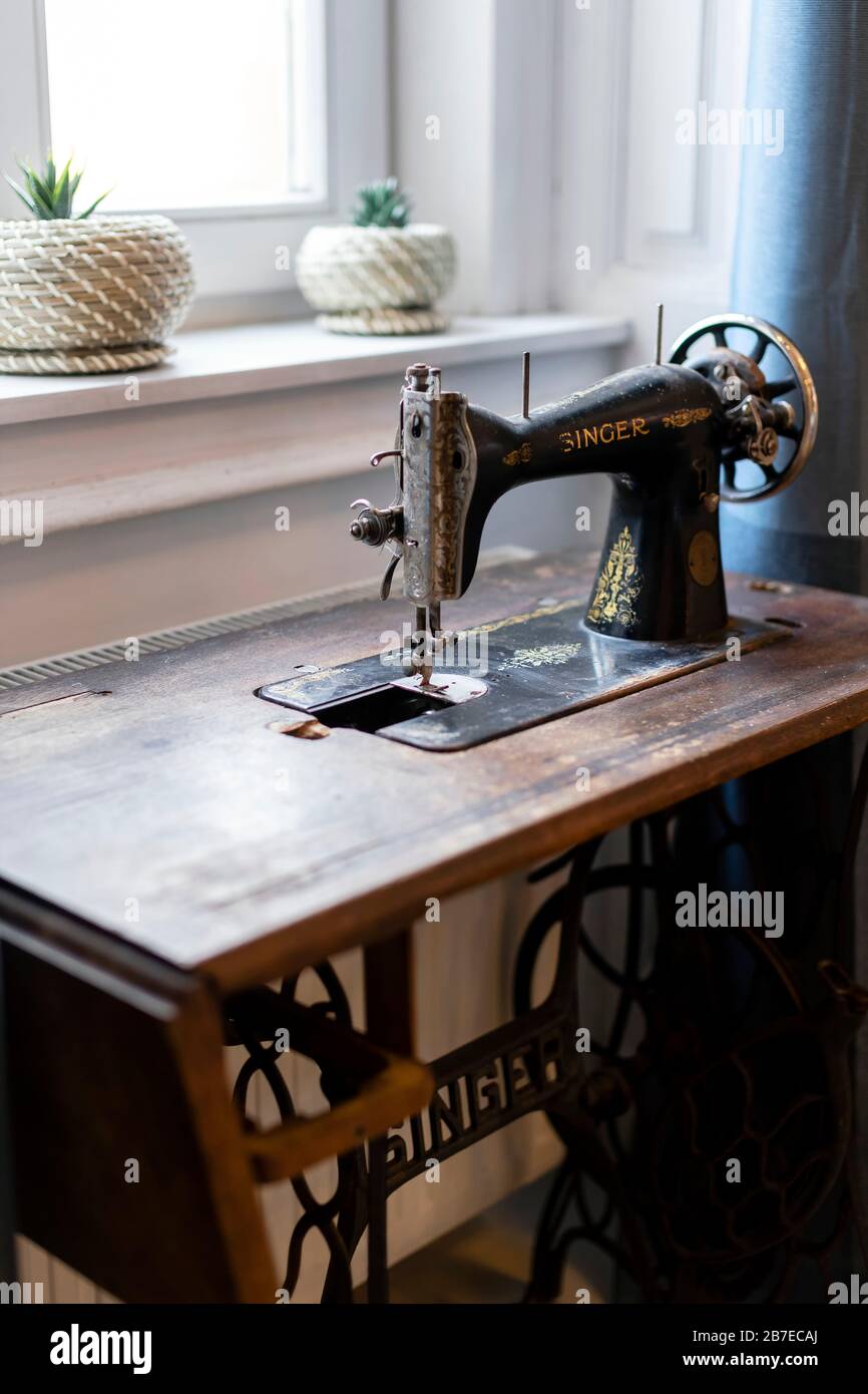 Budapest, Hungary - October 3, 2019: Vintage Singer sewing machine in front of the window - still life, home decor. Stock Photo