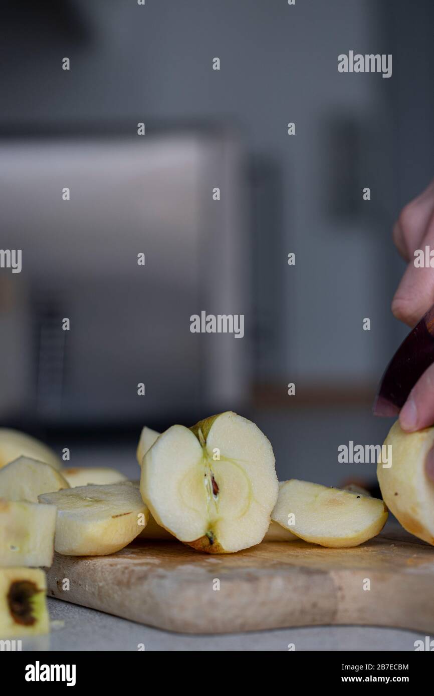 Peeling apples for apple pie hand visible. Stock Photo