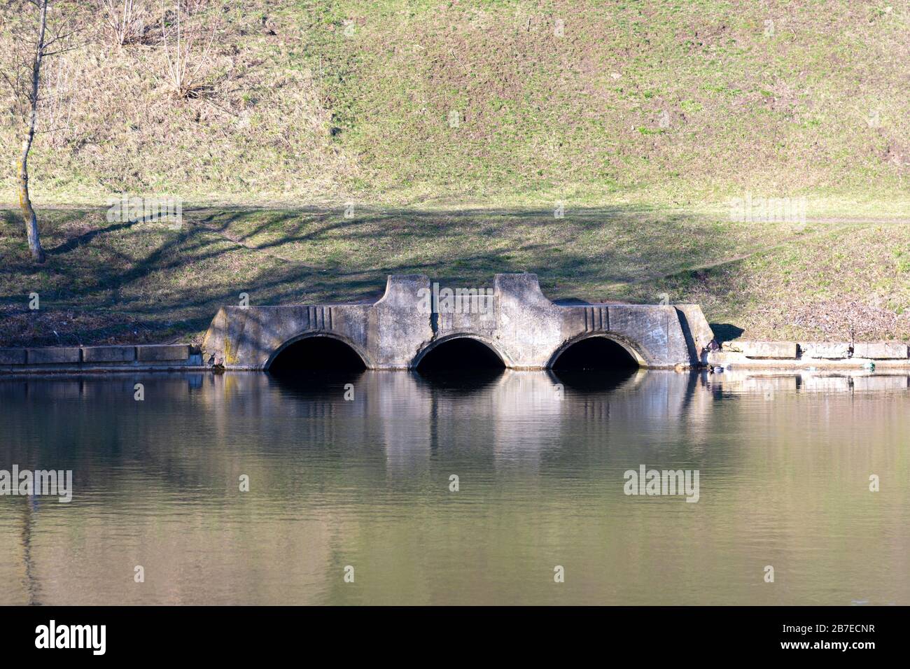 A drain pipe or sewage or sewage discharges waste water into a river. Wastewater or domestic wastewater or municipal wastewater that is a product of a Stock Photo