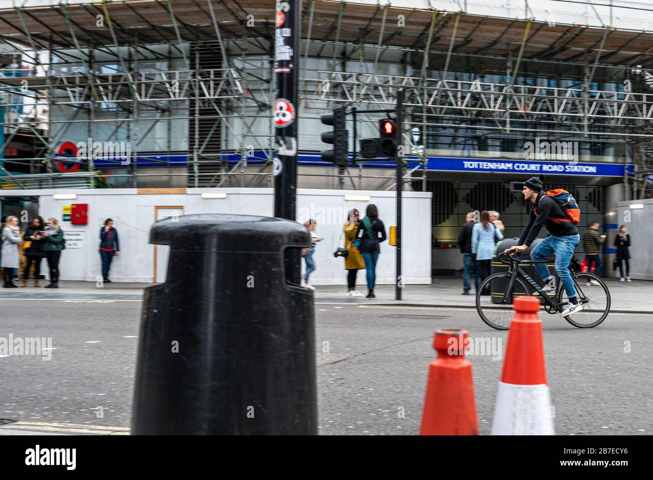 London, UK. 15th March, 2020. Cyclist rushes through Tottenham Court road junction in Central London. While major countries are in total lock down, UK Stock Photo