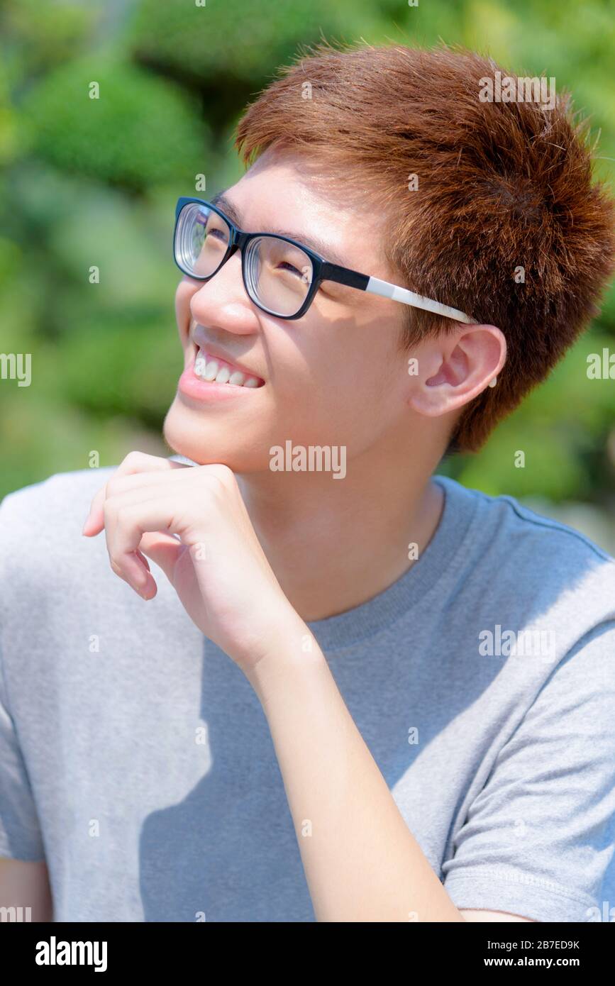 Asian handsome teenage boy wearing glasses fun, Portrait cheerful hipster young man are smiling and laugh with a happy face at park on green nature ba Stock Photo - Alamy Asian handsome teenage boy wearing glasses fun, Portrait cheerful hipster young man are smiling and laugh with a happy face at park on green nature ba Stock Photo - Alamy