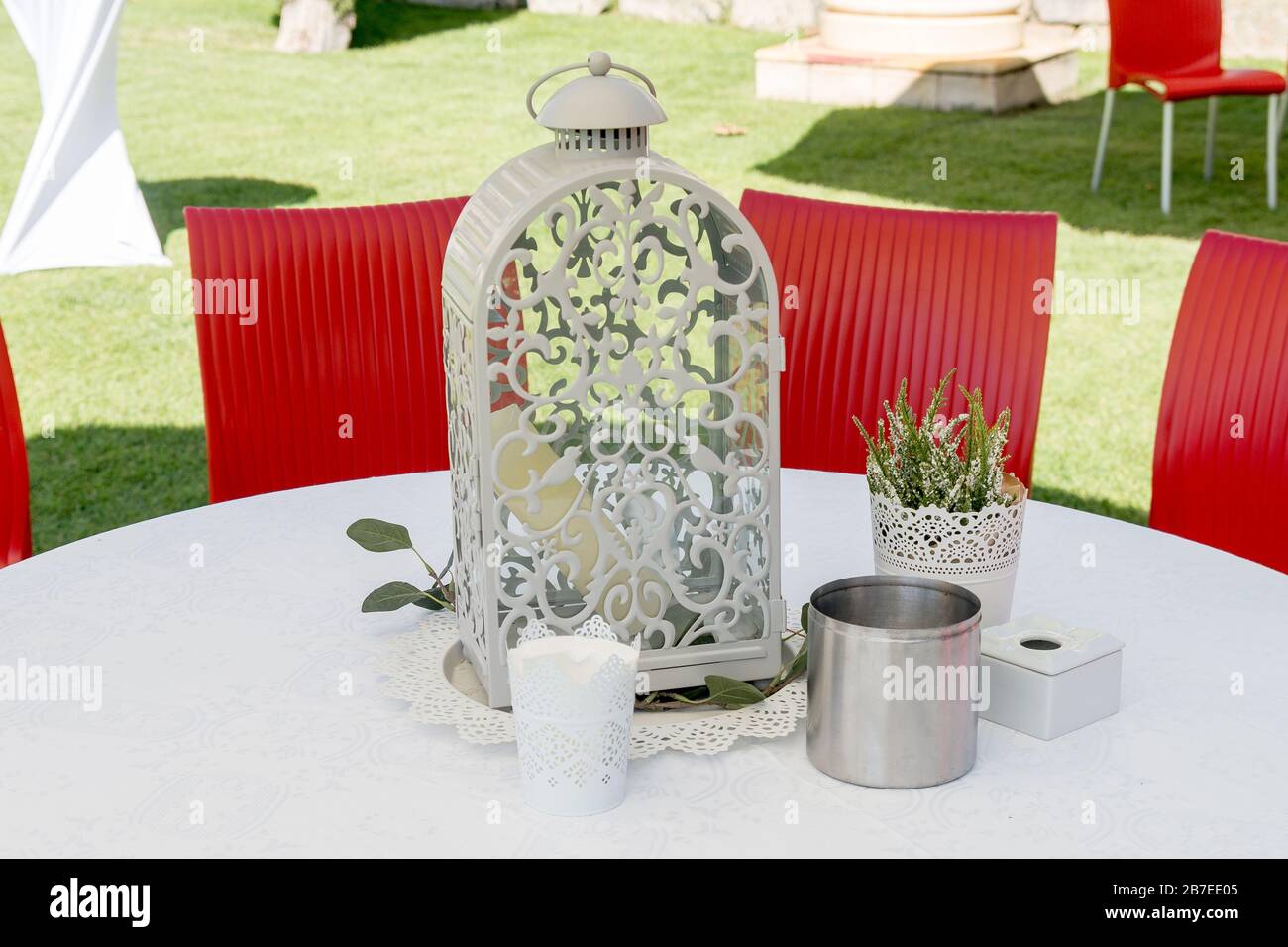 Decoration objects and accessories on table with outdoor chairs. Stock Photo