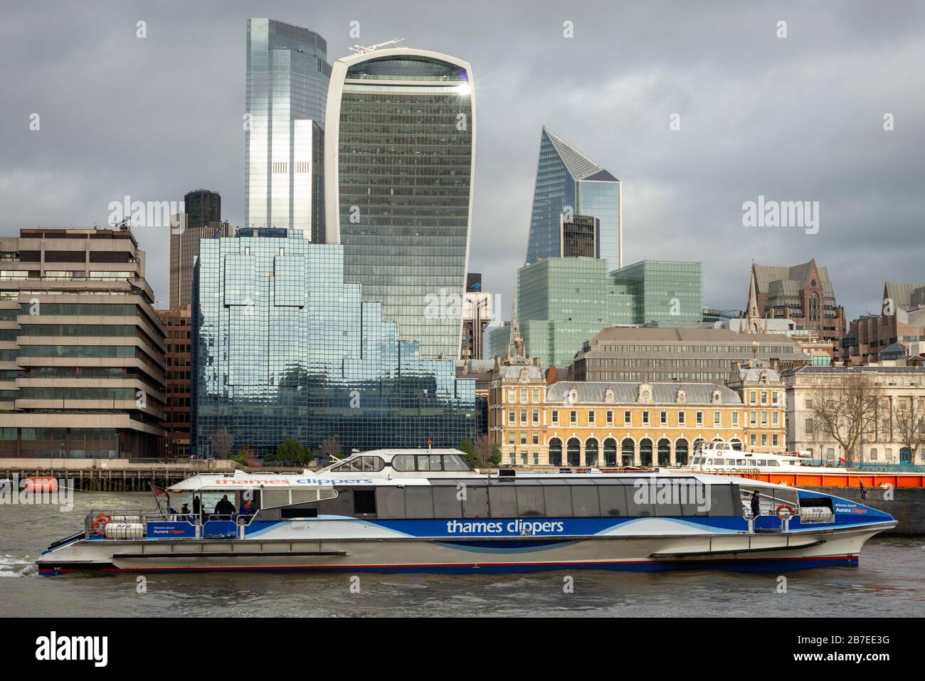 City of London view with Custom House and MBNA Thames Clippers boat as cityscape of the financial district, London, UK as of January 2020 Stock Photo