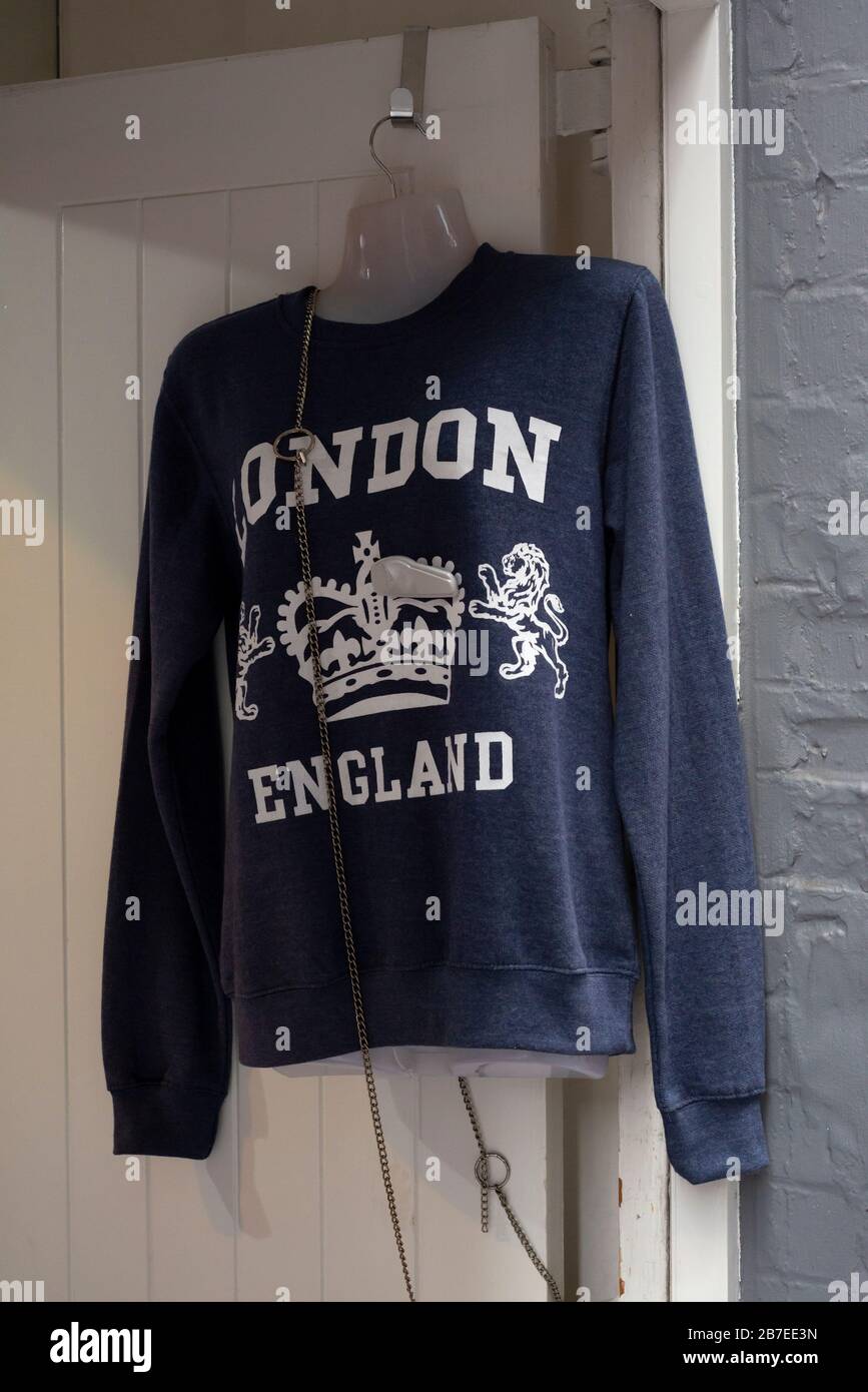 London England text on cheap blue kitsch ugly jumper at souvenir stall in London, United Kingdom Stock Photo