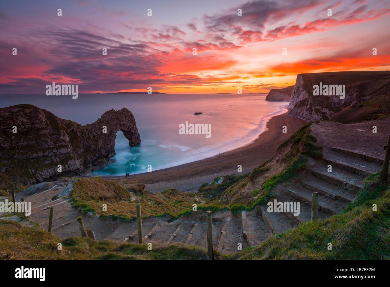 Durdle Door, Lulworth, Dorset, UK.  15th March 2020.  UK Weather.  A spectacular fiery sunset at Durdle Door on the Dorset Jurassic Coast near Lulworth as the cloud clears as high pressure builds in from the South West.  Picture Credit: Graham Hunt/Alamy Live News Stock Photo