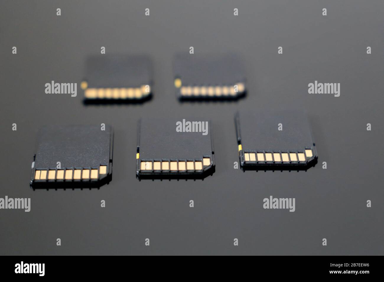 SD memory cards on black glass surface, selective focus. Data storage concept Stock Photo