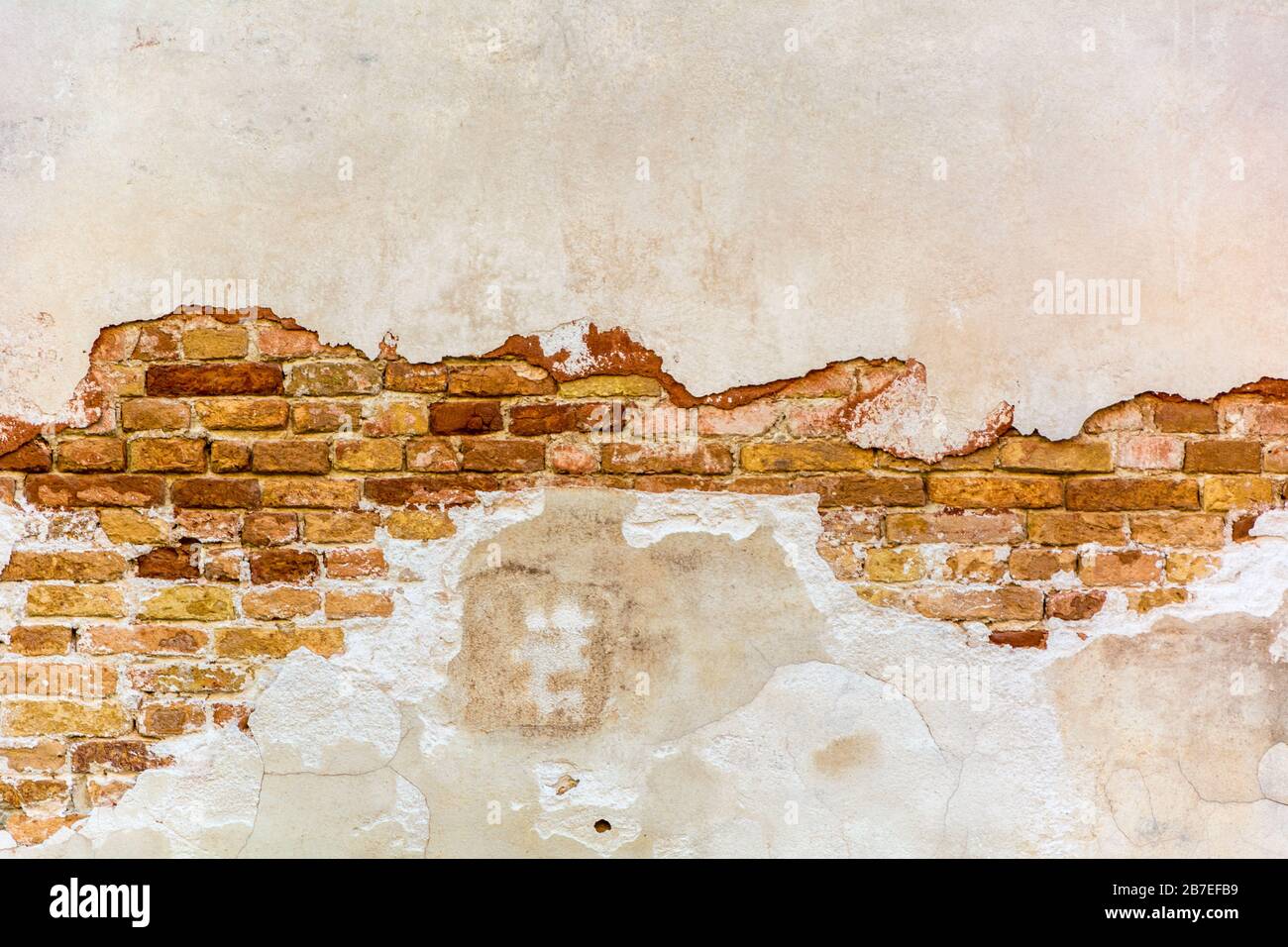 Empty Old Brick Wall and remnants of plaster Texture. Painted