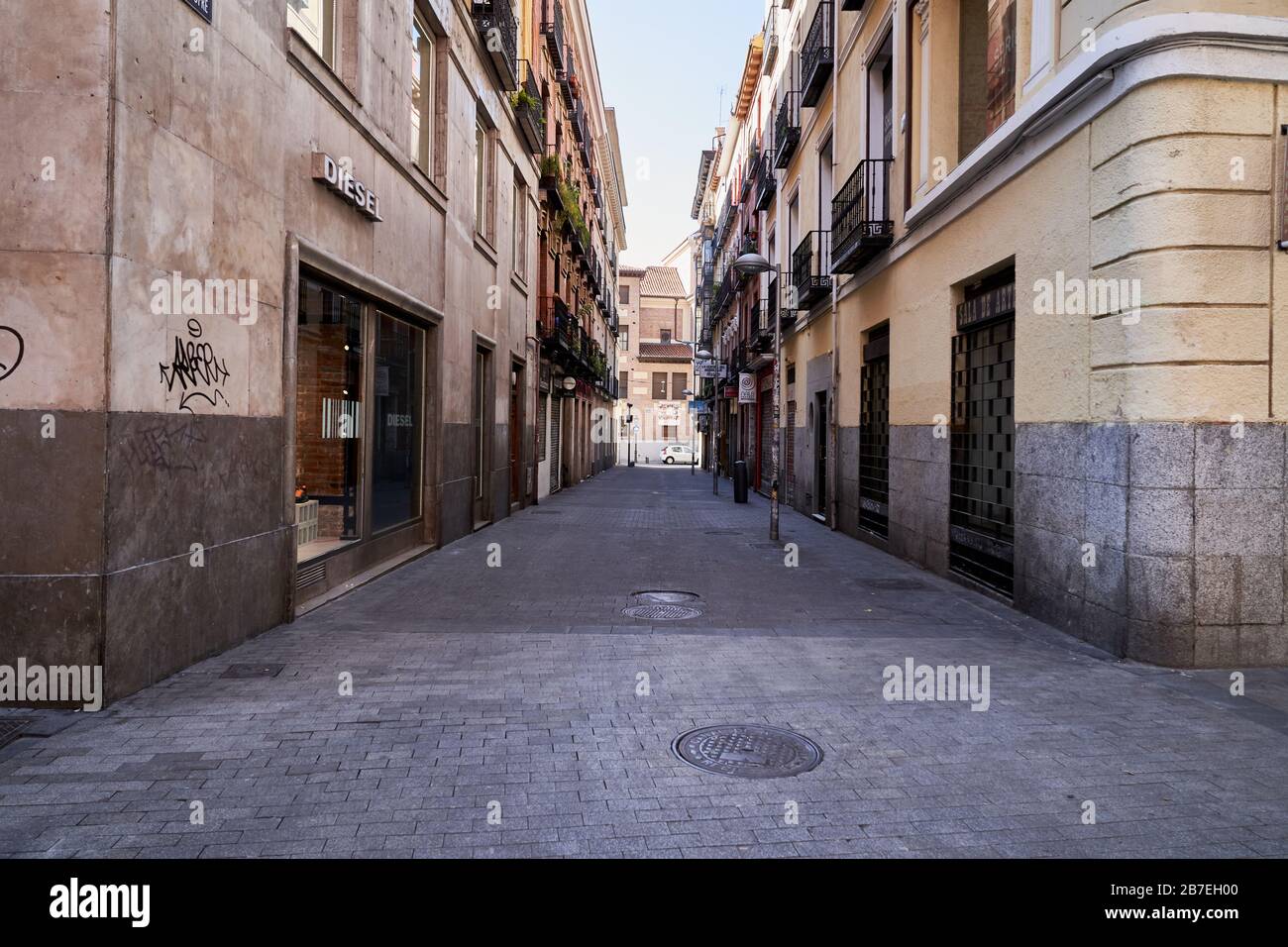 An empty street in the busy neighbourhood of Malasaña Madrid due to the corona virus (covid-19) state of emergency Stock Photo