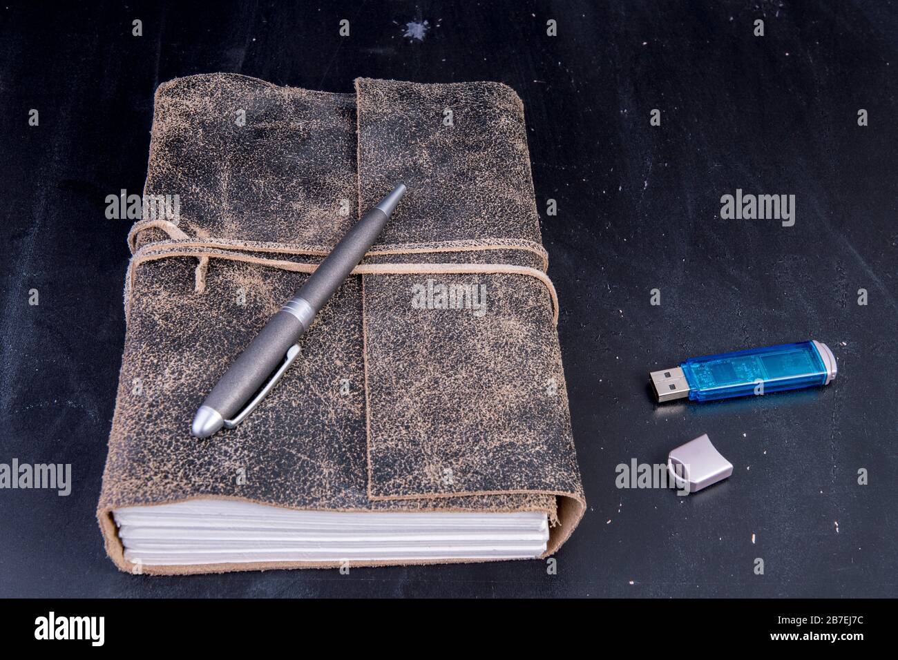 old diary with pen and data stick Stock Photo - Alamy