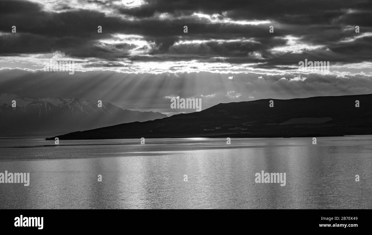 Black and white sunset with rays coming through the clouds Stock Photo