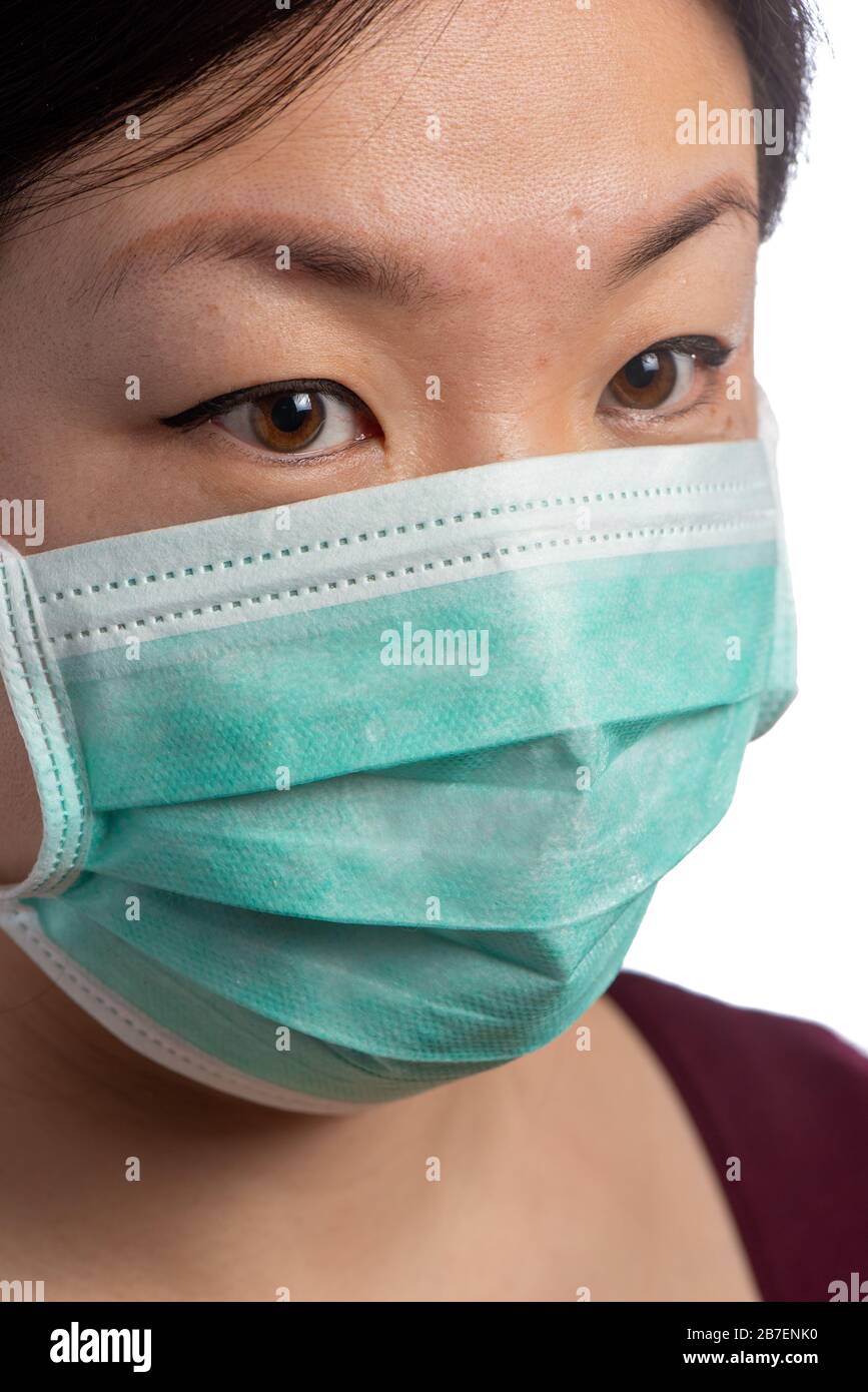 Asian woman wearing a protection mask on a white background Stock Photo