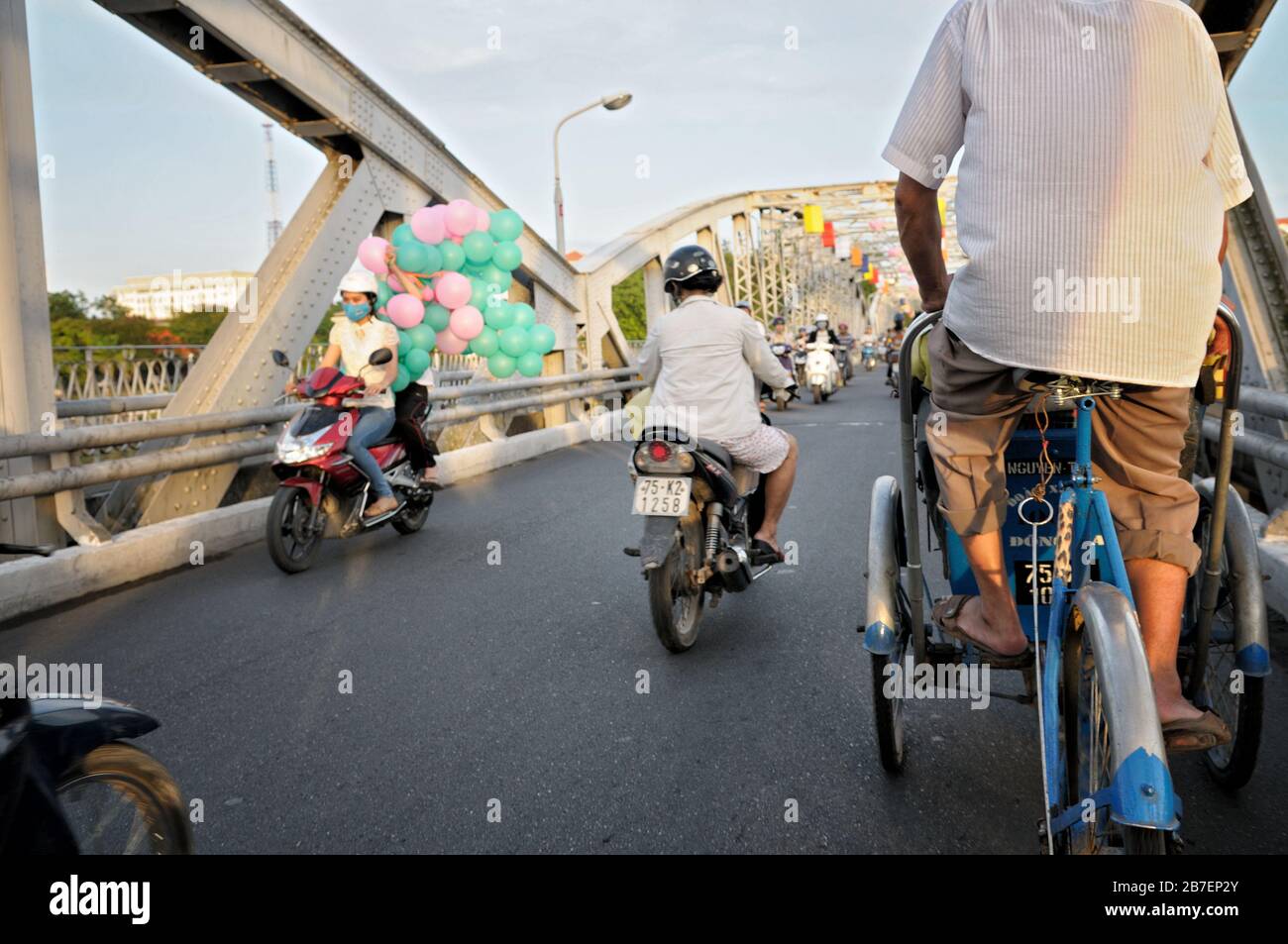 Two-wheeler traffic on Trang Tien bridge in Hue, Vietnam Stock Photo