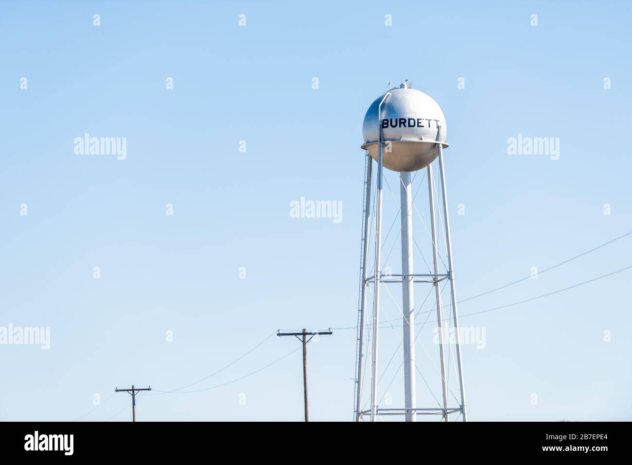 Burdett, USA view of water tower sign on street for city in Kansas countryside industrial town against sky Stock Photo