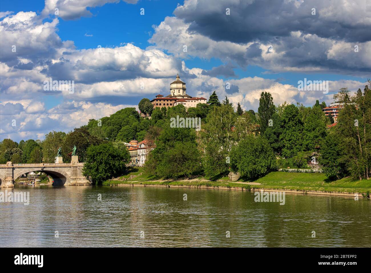View of urban park with green trees along Po river under beautiful sky in Turin, Italy. Stock Photo