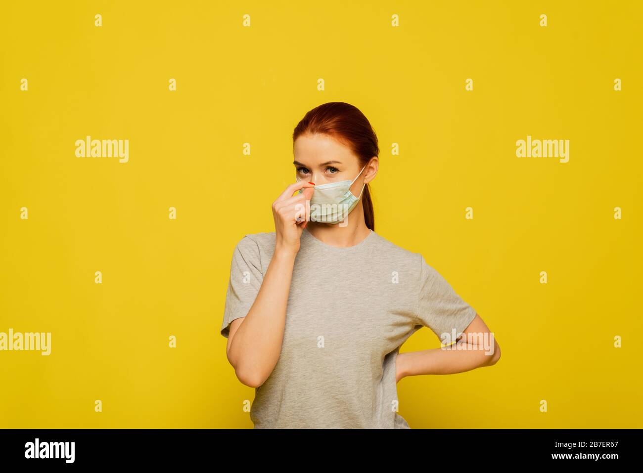 Download Beautiful Woman Put On Medical Mask On A Yellow Background Studio Photo Coronavirus And Covid 19 Concept Studio Portrait Of Young Ill Woman Trying To Put On Medical Flu Mask On Yellow Background PSD Mockup Templates