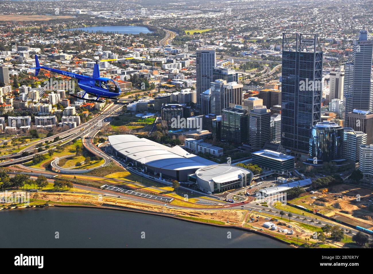 An air to air image of a Robinson R44 helicopter on a scenic flight over the city of Perth, Western Australia. Stock Photo