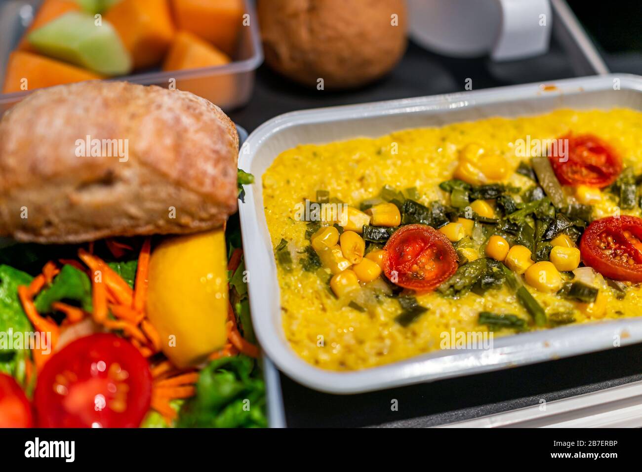 Healthy vegan corn bake food vgml hot meal on airplane flight tray with