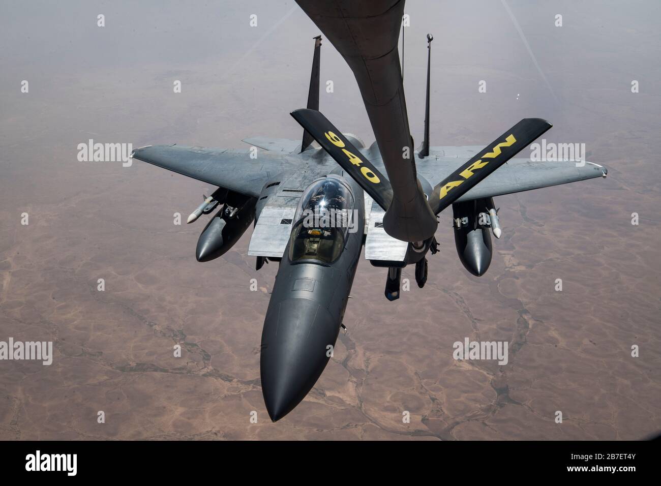 A U.S. Air Force F-15E Strike Eagle approaches a U.S. Air Force KC-135 Stratotanker assigned to the 28th Expeditionary Air Refueling Squadron, to conduct an aerial refueling over Iraq, March 11, 2020. The F-15E is a dual-role fighter designed to perform air-to-air and air-to-air ground missions, demonstrating U.S. Air Forces Central Commands' posture to compete, deter, and win against state and non-state actors. (U.S. Air Force photo by Tech. Sgt. Matthew Lotz) Stock Photo
