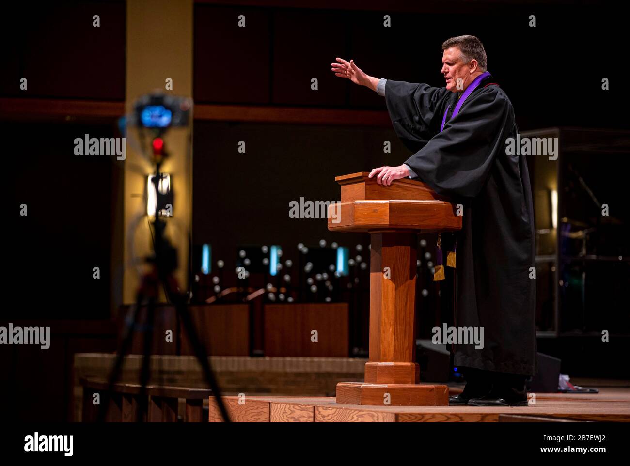 Mar 15, 2020; Springfield, IL, USA; Rev. Roger Grimmett delivers his message to an empty sanctuary and a camera crew for First United Methodist Church's Sunday morning service for the first time due to restrictions of large gatherings because of COVID-19, Sunday, March 15, 2020, in Springfield, Ill. First United Methodist Church live streamed their 9 a.m. traditional service as well as their 10:30 a.m. contemporary service on the church's Facebook page because of the restrictions. It's the first time the church has closed to corporate worship since 1918 at the height of the flu epidemic. Man Stock Photo