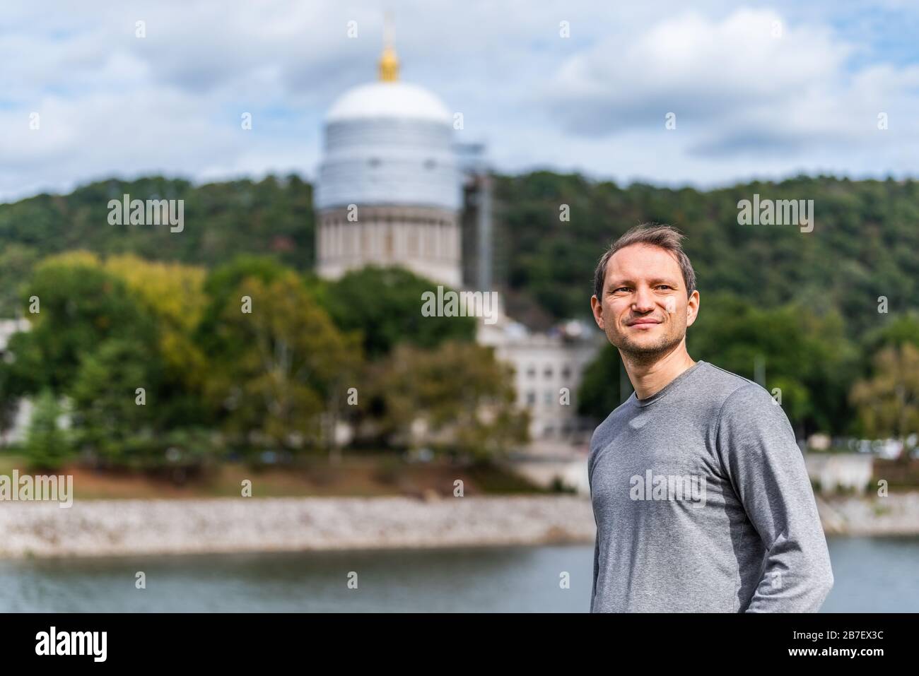 Charleston, West Virginia capital city with happy man looking away by scaffold construction on state capitol dome Stock Photo