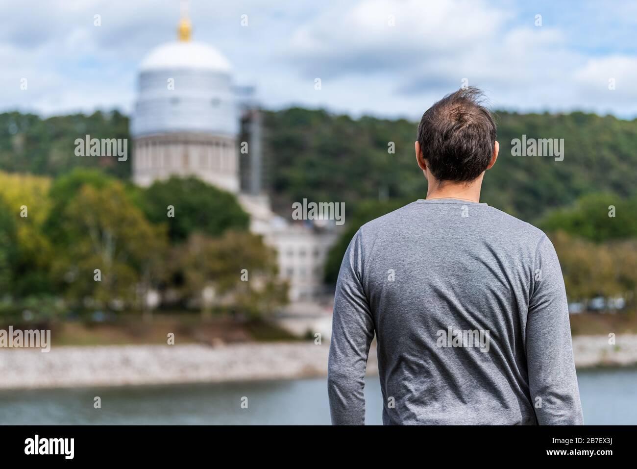 Charleston, West Virginia capital city with back of man looking at scaffold construction on state capitol dome Stock Photo