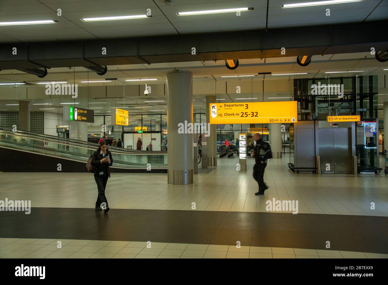 very quiet airport Schiphol caused by closedown of shops, cafes and restaurants by government because of corona virus in Holland Stock Photo