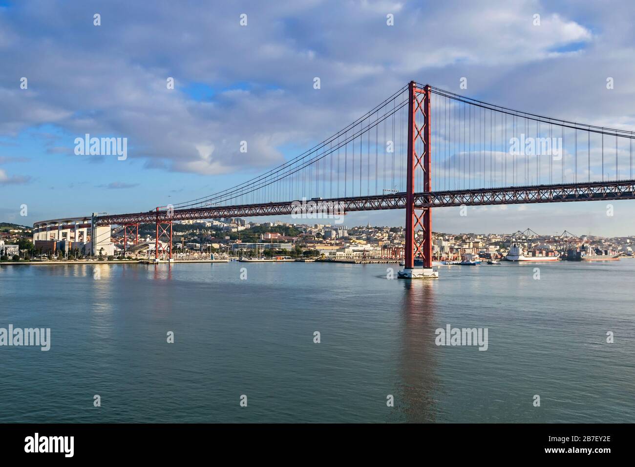 Left (south) bank of the Tagus river and the 25 de Abril Bridge, a suspension bridge connecting the city of Lisbon, capital of Portugal, to the munici Stock Photo
