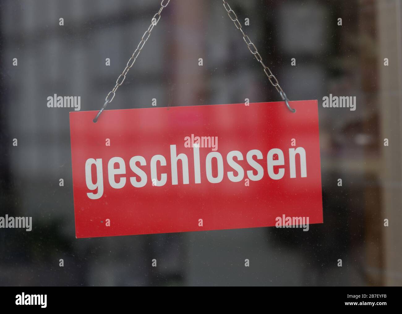 closeup of a sign on a glass door with the german word geschlossen means closed Stock Photo