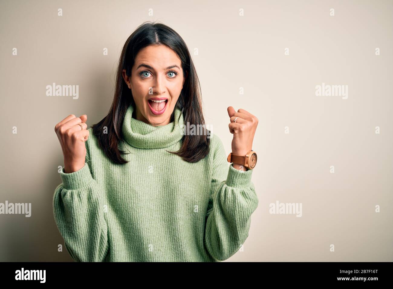 Young brunette woman with blue eyes wearing turtleneck sweater over ...