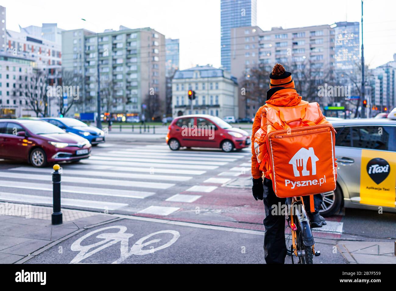 Warsaw, Poland - December 19, 2019: Pyszne.pl courier in orange work clothes  delivery man delivering online food orders on bicycle in winter Stock Photo  - Alamy