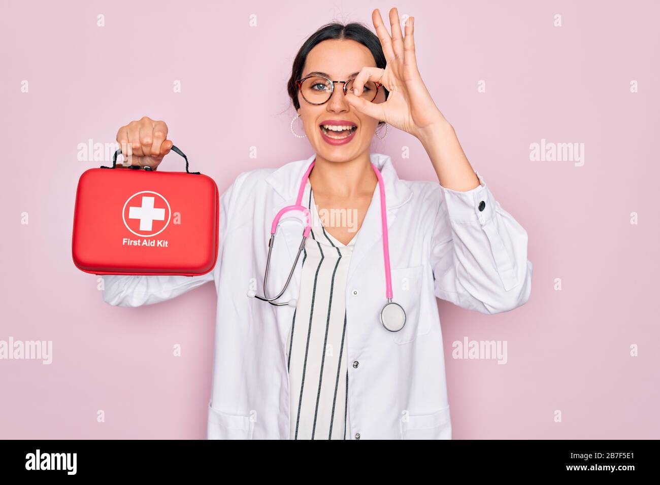 Young beautiful doctor woman with blue eyes wearing stethoscope holding ...