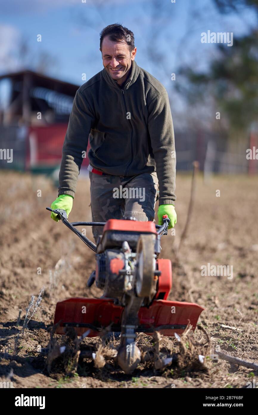 Farmer weeding with a motorized tiller on a lavender field Stock Photo Alamy