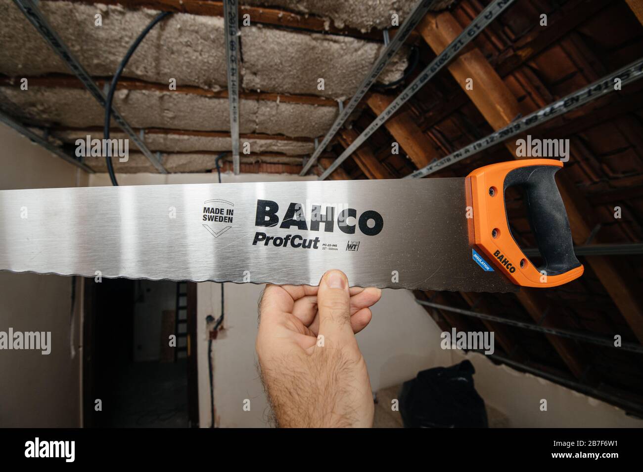 Paris, France Mar 10, 2020 Male hand holding against construction