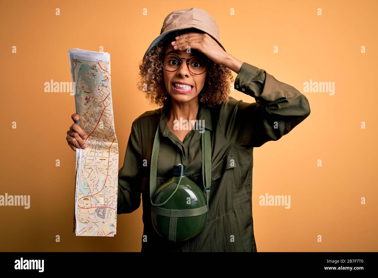 African american tourist woman wearing explorer hat and water canteen ...