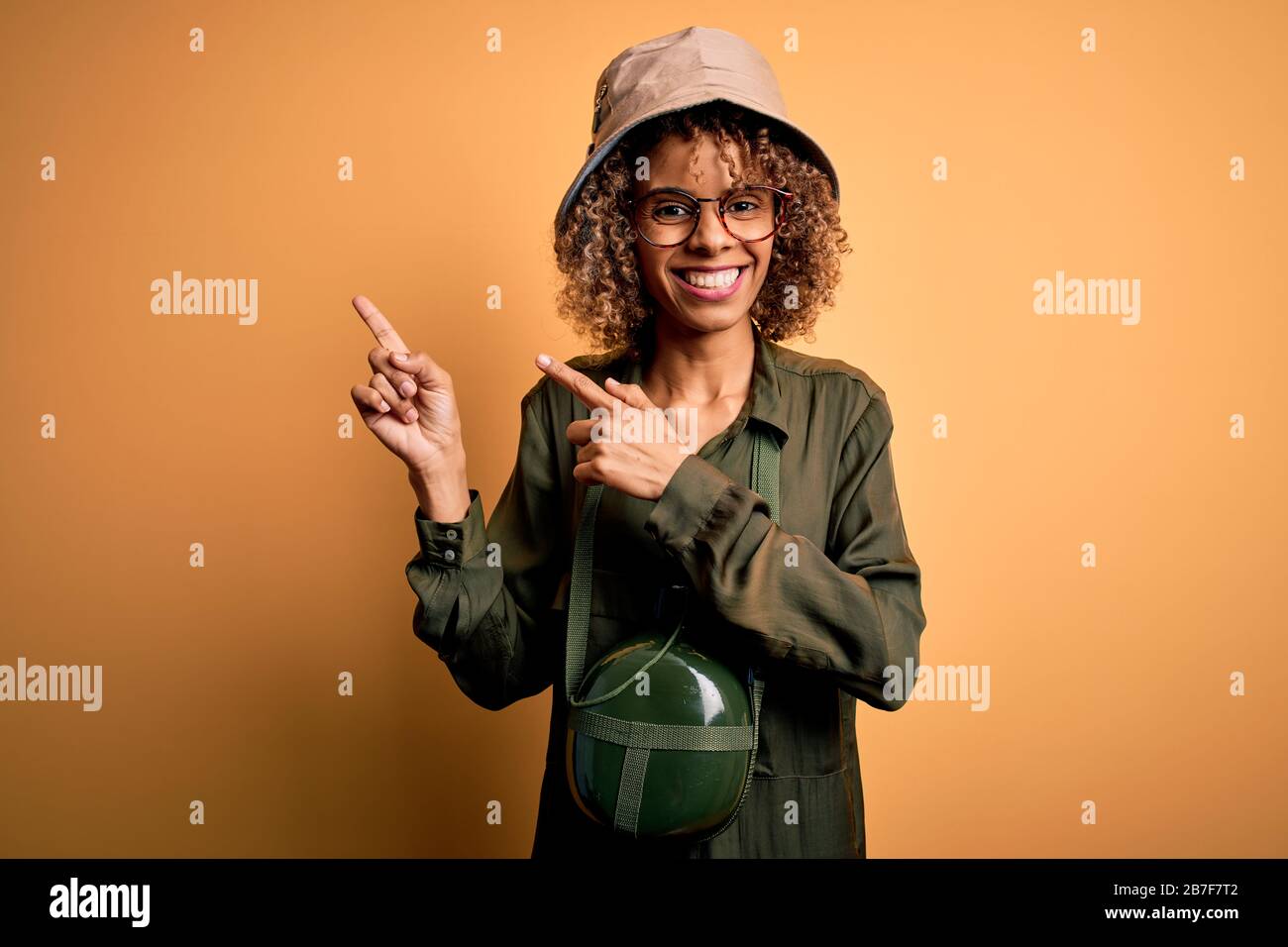 Young african american tourist woman on vacation wearing explorer hat ...