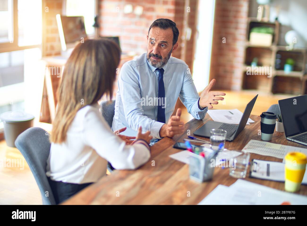 Two middle age business workers smiling happy and confident. Working ...