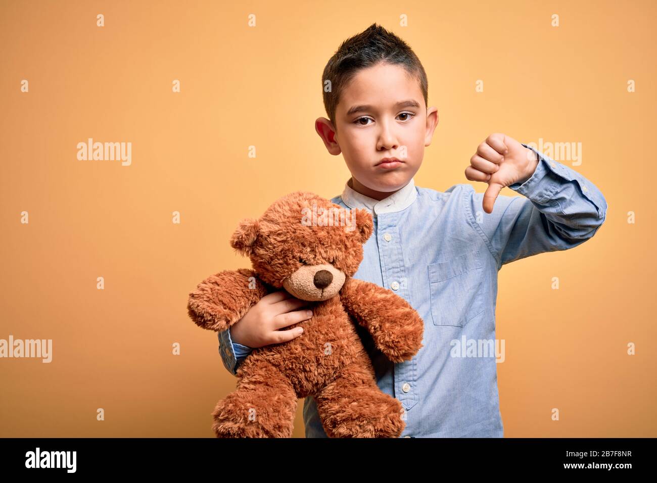 Kid hugging teddy bear on sale