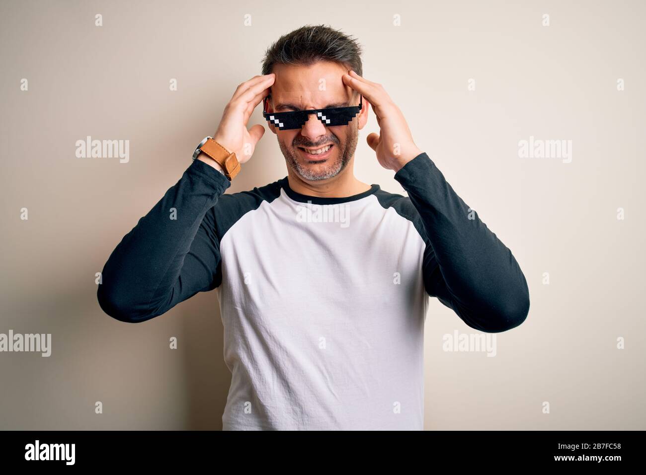 Young handsome man wearing funny thug life sunglasses meme over white  background suffering from headache desperate and stressed because pain and  migra Stock Photo - Alamy