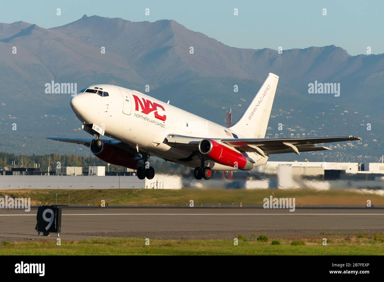 Northern Air Cargo Boeing 737 Cargo departing Anchorage Airport in Alaska. 737-200F aircraft, a classic freighter airplane. Registered as N320DL. Stock Photo